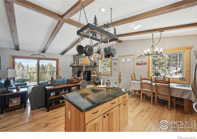 10649 Christopher Dr, Conifer, CO 80433 - kitchen featuring beamed ceiling, a textured ceiling, and light wood-type flooring