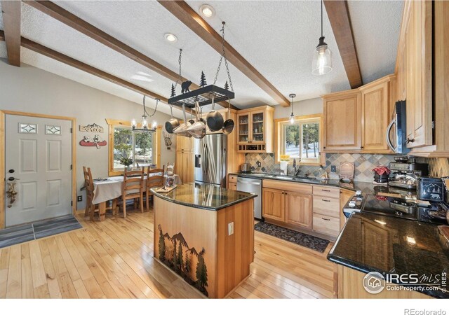 10649 Christopher Dr, Conifer, CO 80433 - kitchen with a sink, lofted ceiling with beams, light wood-style floors, backsplash, and appliances with stainless steel finishes