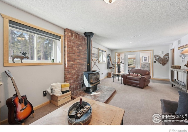 10649 Christopher Dr, Conifer, CO 80433 - living room with a wood stove, a textured ceiling, and plenty of natural light