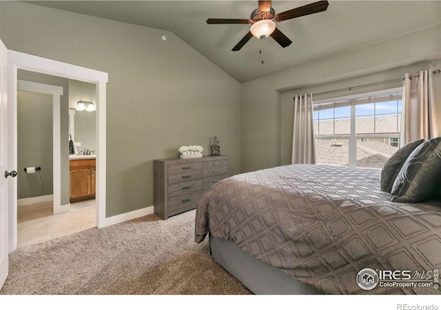 bedroom featuring vaulted ceiling, a ceiling fan, light tile patterned floors, light carpet, and baseboards