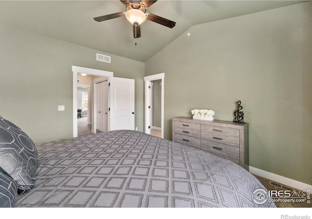 bedroom with a ceiling fan, vaulted ceiling, visible vents, and carpet floors