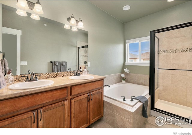 full bath featuring a bath, a shower stall, and a sink