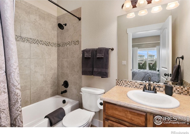 ensuite bathroom with tasteful backsplash, toilet, ensuite bathroom, shower / tub combo with curtain, and vanity
