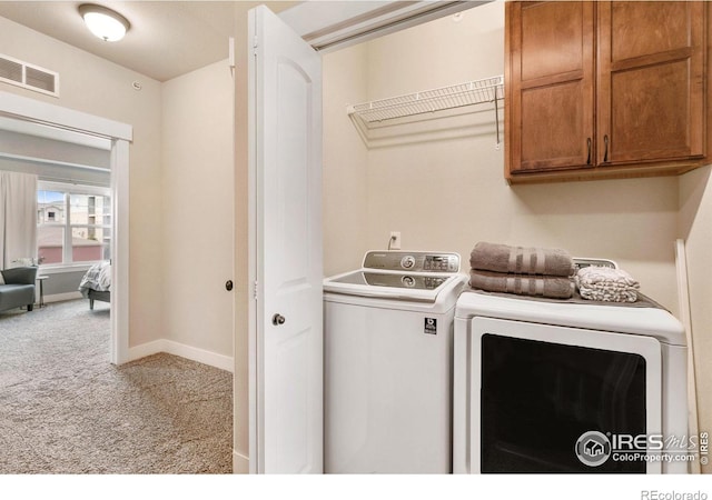 laundry area with washer and dryer, cabinet space, baseboards, carpet flooring, and visible vents