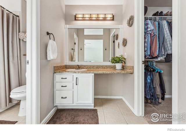 4774 Coker Ave, Castle Rock, CO 80104 - bathroom featuring tile patterned floors, vanity, a walk in closet, toilet, and baseboards