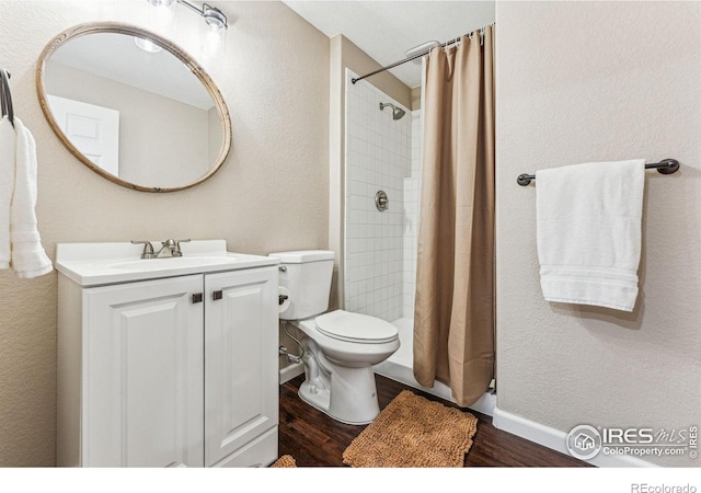 4774 Coker Ave, Castle Rock, CO 80104 - full bath with wood finished floors, toilet, vanity, a tile shower, and a textured wall
