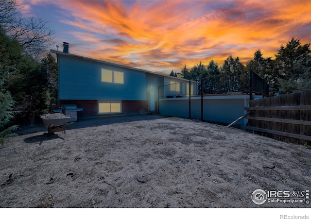 17492 County Road 29, Brush, CO 80723 - back of property at dusk featuring a chimney and fence