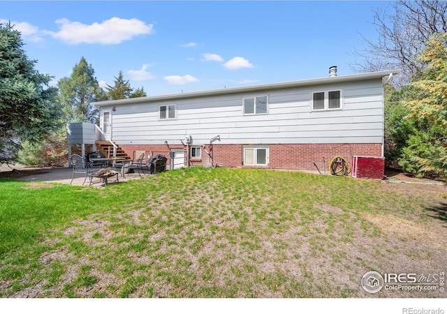 17492 County Road 29, Brush, CO 80723 - back of house featuring stairway, a yard, and a patio