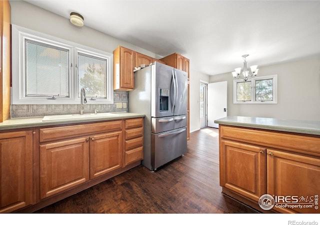 17492 County Road 29, Brush, CO 80723 - kitchen with a sink, an inviting chandelier, light countertops, dark wood finished floors, and stainless steel refrigerator with ice dispenser