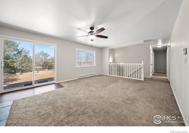 17492 County Road 29, Brush, CO 80723 - spare room featuring a baseboard heating unit, baseboards, a ceiling fan, and carpet flooring