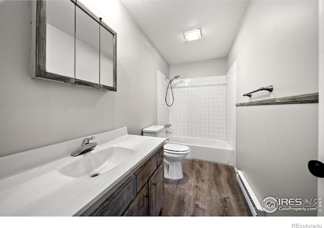 17492 County Road 29, Brush, CO 80723 - bathroom with wood finished floors, toilet, vanity, tub / shower combination, and baseboard heating