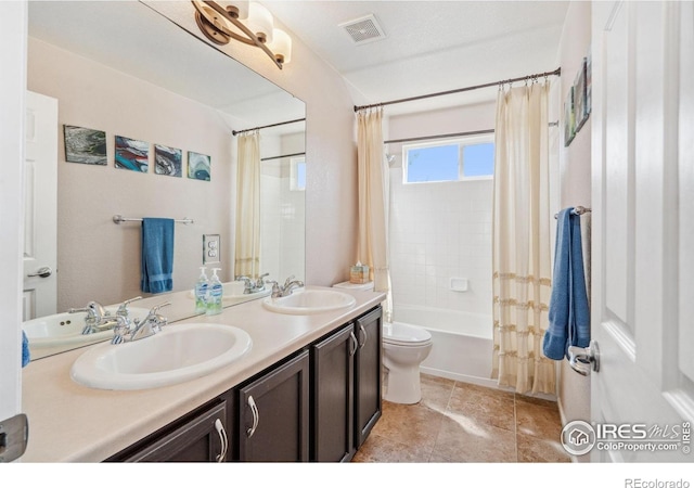 bathroom featuring double vanity, visible vents, shower / bath combination with curtain, and a sink