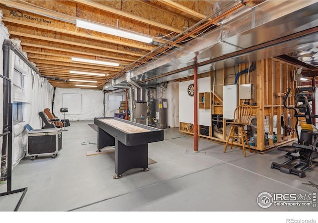game room with water heater and finished concrete floors