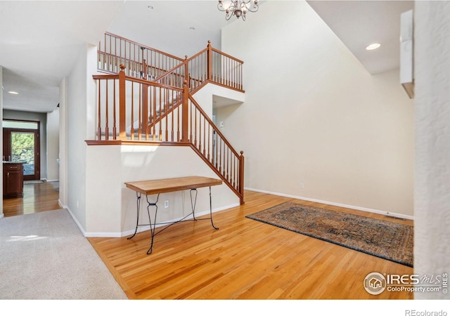 11676 Montgomery Cir, Longmont, CO 80504 - stairway with wood finished floors, a chandelier, and recessed lighting