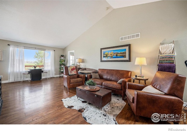 2190 Coyote Creek Dr, Fort Lupton, CO 80621 - living room featuring wood finished floors, high vaulted ceiling, and baseboards