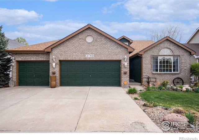 2190 Coyote Creek Dr, Fort Lupton, CO 80621 - view of front of house featuring brick siding, an attached garage, concrete driveway, and a shingled roof