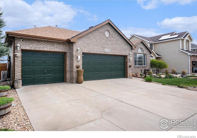 2190 Coyote Creek Dr, Fort Lupton, CO 80621 - view of front facade featuring an attached garage, driveway, brick siding, and a shingled roof