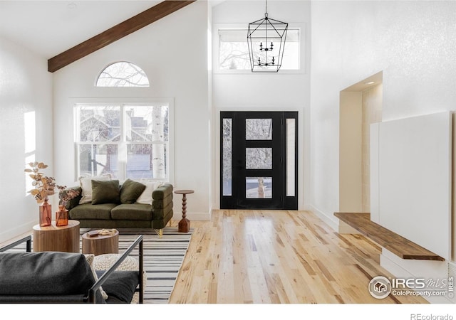 1012 Hobson Ct, Fort Collins, CO 80526 - entrance foyer with high vaulted ceiling, a chandelier, wood finished floors, beamed ceiling, and plenty of natural light