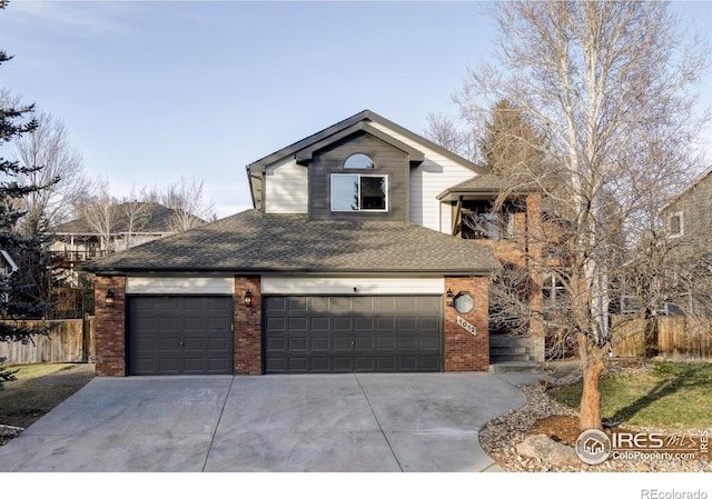 1012 Hobson Ct, Fort Collins, CO 80526 - view of front facade with brick siding, driveway, a shingled roof, and fence