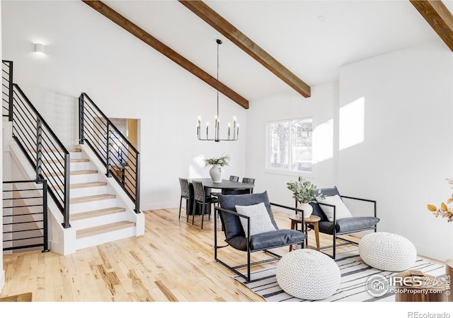 1012 Hobson Ct, Fort Collins, CO 80526 - living area featuring a chandelier, stairs, wood finished floors, and baseboards