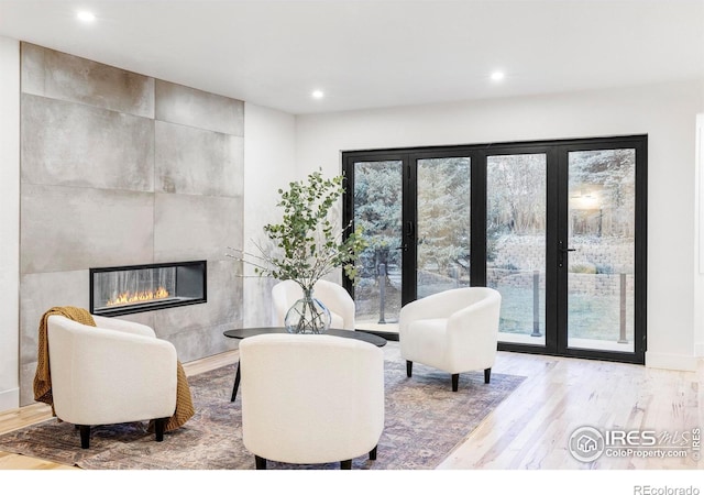 1012 Hobson Ct, Fort Collins, CO 80526 - living area featuring wood finished floors, recessed lighting, and a tiled fireplace