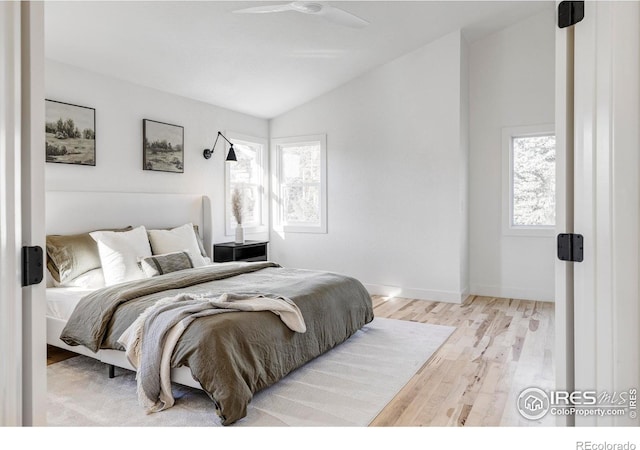 1012 Hobson Ct, Fort Collins, CO 80526 - bedroom featuring vaulted ceiling, multiple windows, wood finished floors, and baseboards