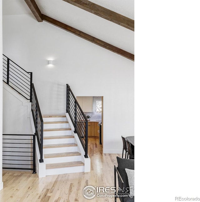 1012 Hobson Ct, Fort Collins, CO 80526 - stairs featuring beamed ceiling, wood finished floors, and high vaulted ceiling