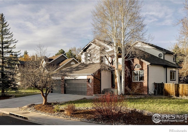 1012 Hobson Ct, Fort Collins, CO 80526 - view of front facade featuring concrete driveway, brick siding, and an attached garage