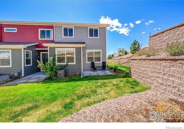 rear view of property with cooling unit, fence, a yard, and a patio