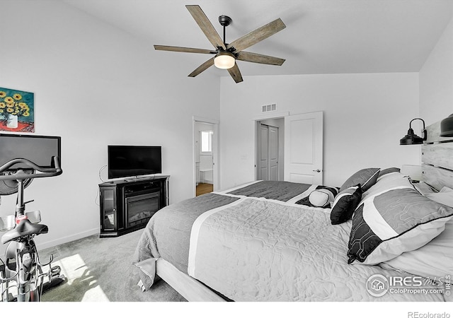 bedroom with vaulted ceiling, ceiling fan, baseboards, carpet flooring, and visible vents
