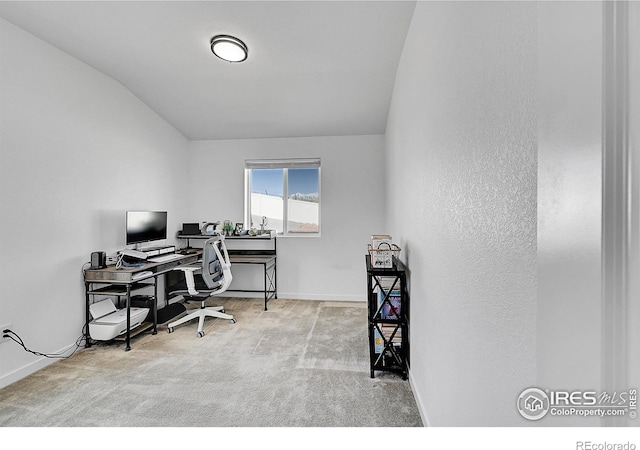 office area with carpet floors, vaulted ceiling, and baseboards