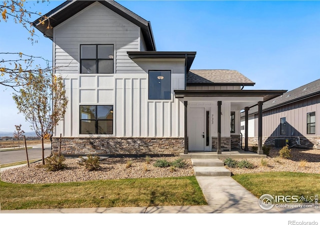 view of front of home with board and batten siding and stone siding