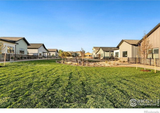 view of yard featuring fence and a residential view