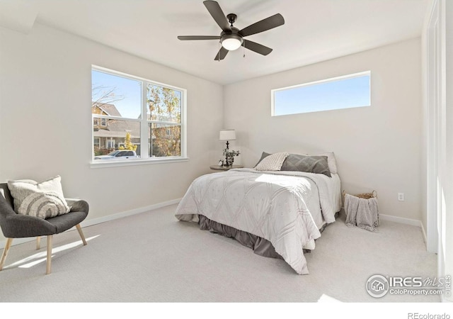 carpeted bedroom featuring a ceiling fan and baseboards
