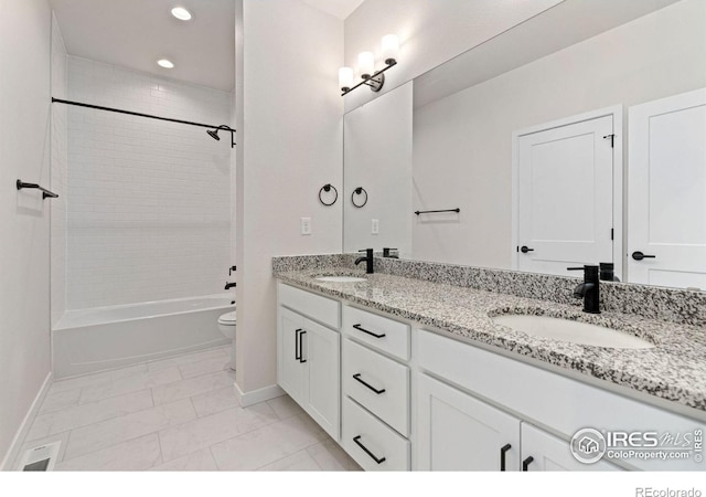 full bath with baseboards, toilet, and a sink