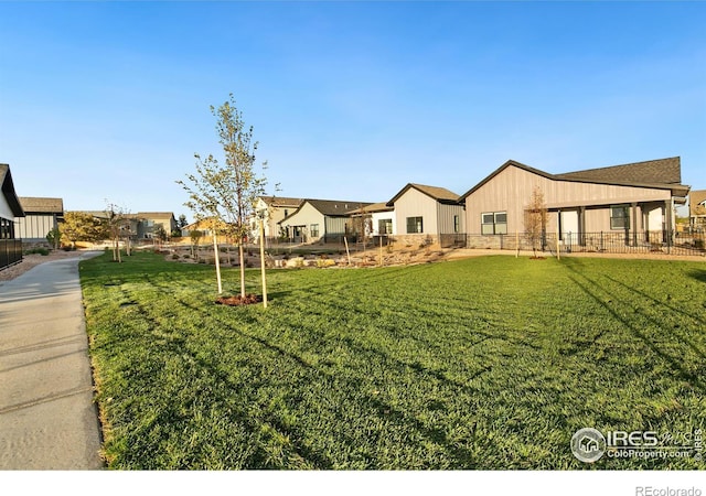 view of yard featuring fence and a residential view