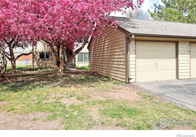 3465 Lochwood Dr Unit G-32, Fort Collins, CO 80525 - view of side of property with roof with shingles and a garage