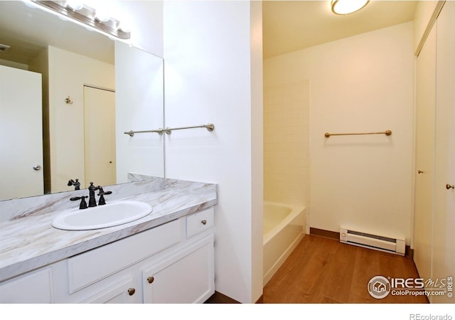 3465 Lochwood Dr Unit G-32, Fort Collins, CO 80525 - full bath with wood finished floors, vanity, baseboard heating, and visible vents