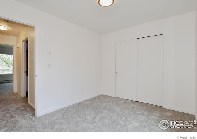 3465 Lochwood Dr Unit G-32, Fort Collins, CO 80525 - unfurnished bedroom with a baseboard radiator, baseboards, a closet, and carpet
