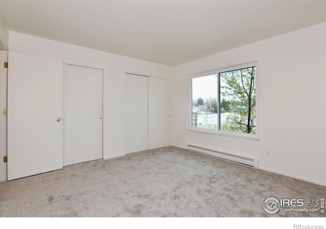 3465 Lochwood Dr Unit G-32, Fort Collins, CO 80525 - unfurnished bedroom with baseboard heating, carpet, and multiple closets