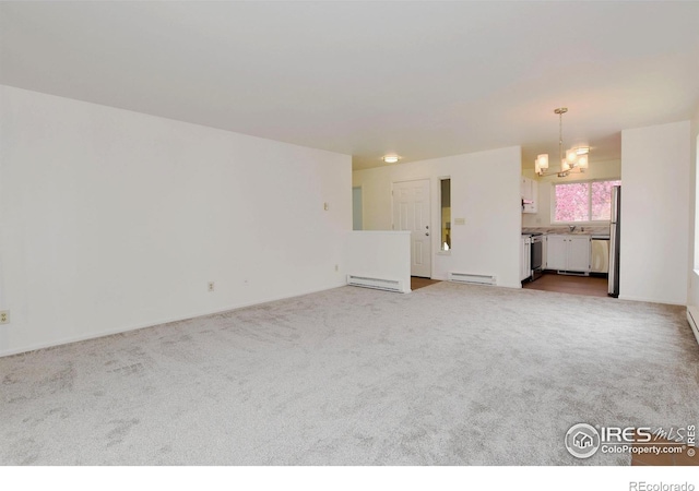 3465 Lochwood Dr Unit G-32, Fort Collins, CO 80525 - unfurnished living room featuring a baseboard heating unit, carpet, and an inviting chandelier
