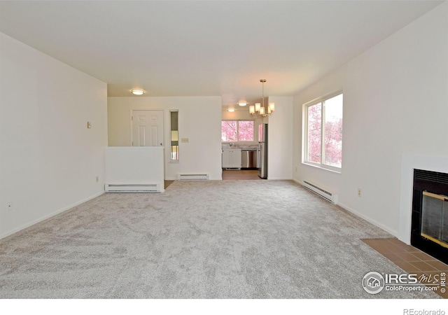 3465 Lochwood Dr Unit G-32, Fort Collins, CO 80525 - unfurnished living room featuring a baseboard radiator, an inviting chandelier, and a fireplace