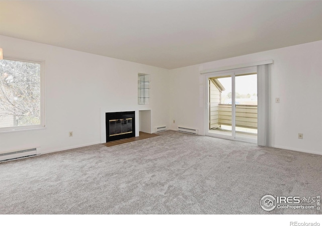 3465 Lochwood Dr Unit G-32, Fort Collins, CO 80525 - unfurnished living room with a baseboard heating unit, carpet floors, a fireplace with flush hearth, and baseboards