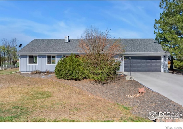 7859 Whitetail Cir, Wellington, CO 80549 - single story home with board and batten siding, an attached garage, driveway, and a shingled roof