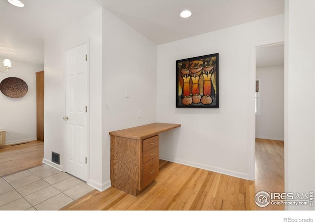 corridor with light wood-type flooring, baseboards, recessed lighting, and visible vents