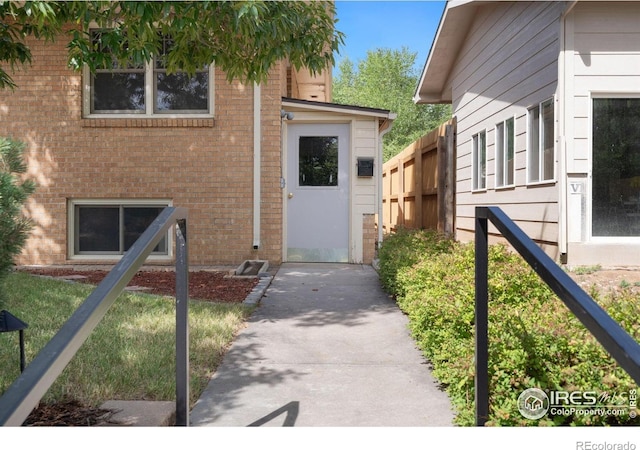 entrance to property featuring brick siding