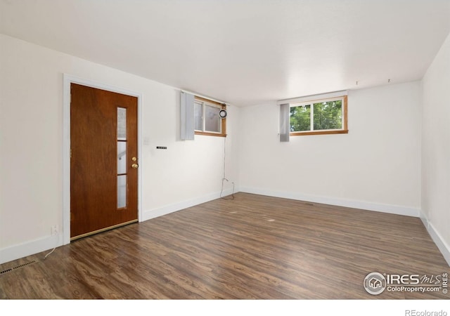 interior space with wood finished floors and baseboards