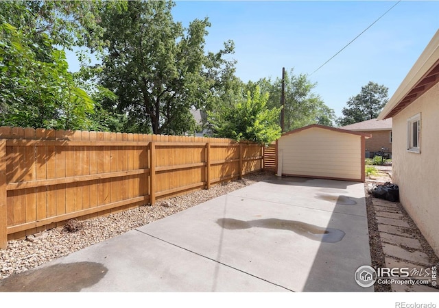 view of patio / terrace featuring a storage shed, an outbuilding, and a fenced backyard