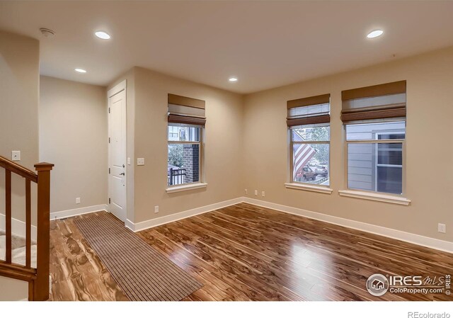 8482 Parkland St, Broomfield, CO 80021 - unfurnished room with wood finished floors, baseboards, stairs, and recessed lighting