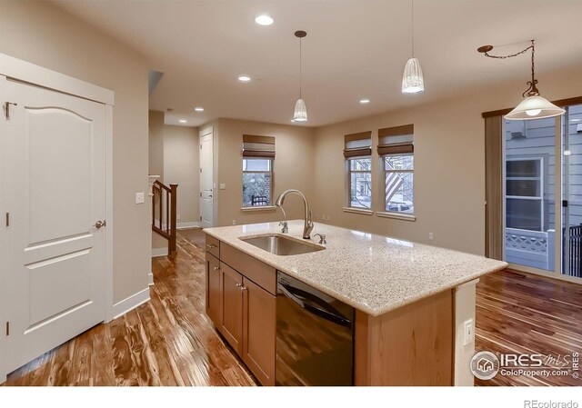 8482 Parkland St, Broomfield, CO 80021 - kitchen with a sink, black dishwasher, hanging light fixtures, light wood finished floors, and recessed lighting